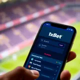 Mobile phone showing the 1xBet Nigeria login app interface with account login options and betting markets
